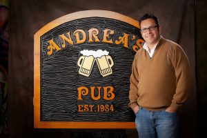 Jim Standing nest to Andrea's Pub Sign